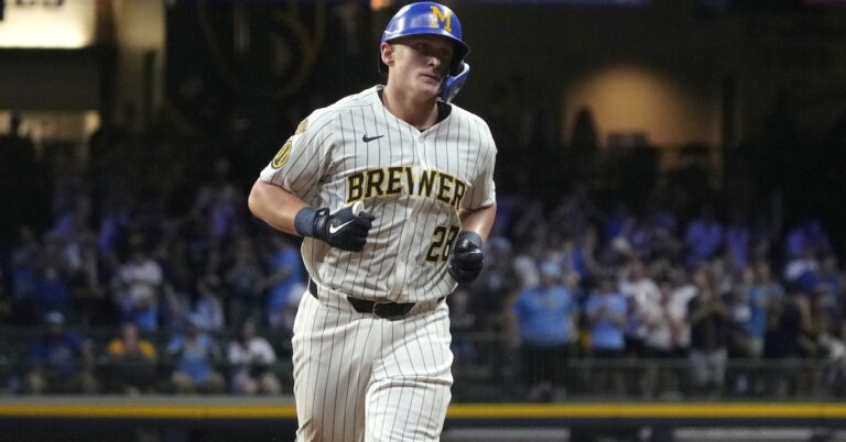 Andrew Vaughn swinging a bat – 2026 fantasy baseball waiver wire must-add player.